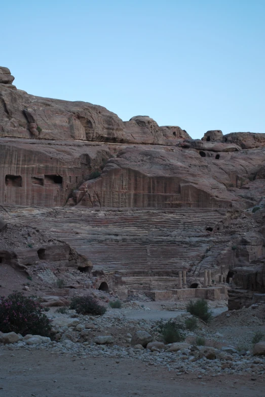 a rocky hill with an empty stairway at the base of it