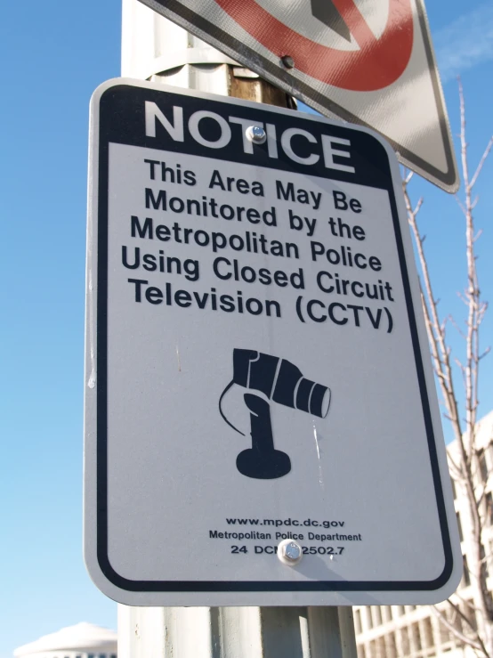 a street sign on a metal pole next to buildings