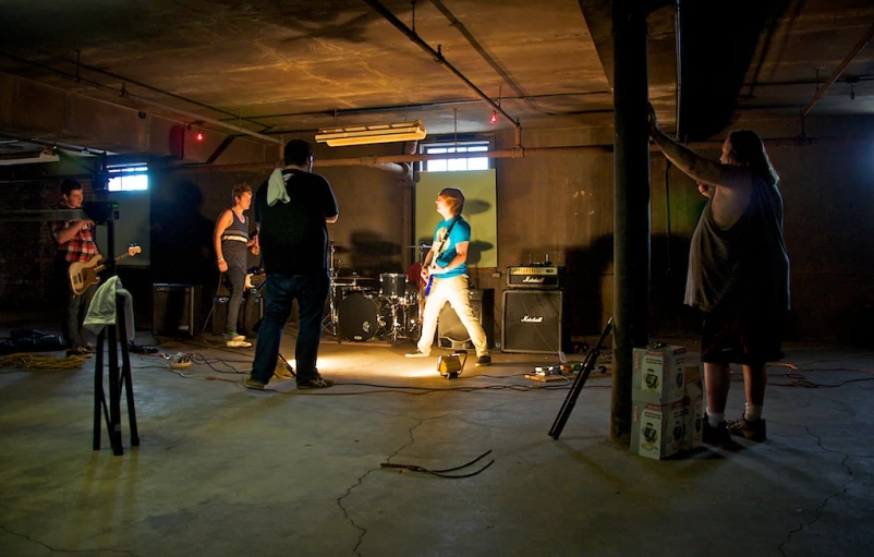 a group of people playing music in a dark room
