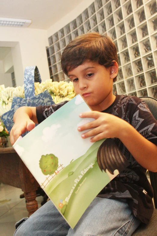 a boy reading a book about animals and their names