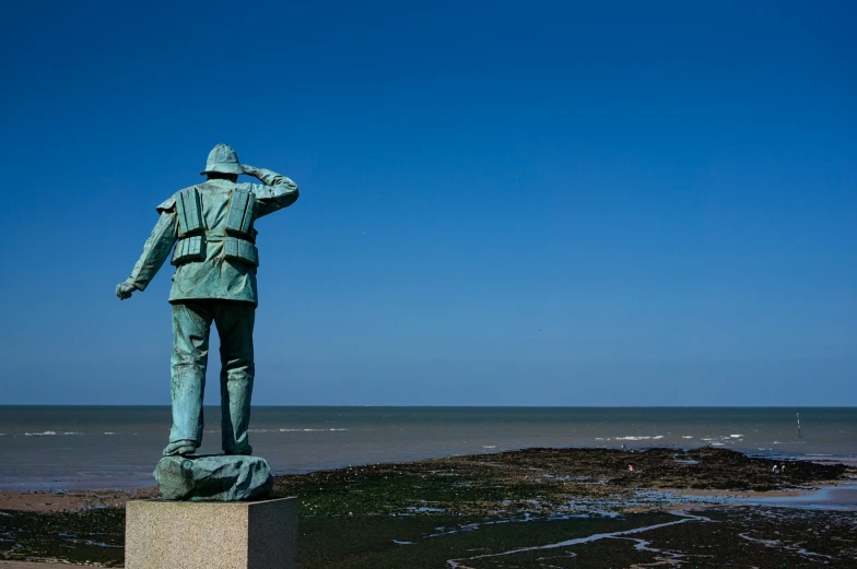 a statue of a man is near the water