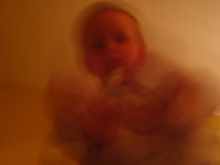 blurry image of a person standing in a room