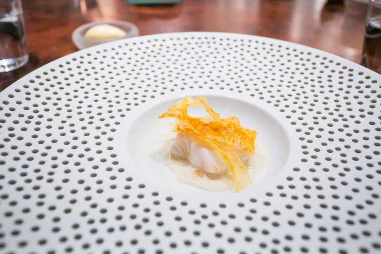 a white plate topped with food next to glasses