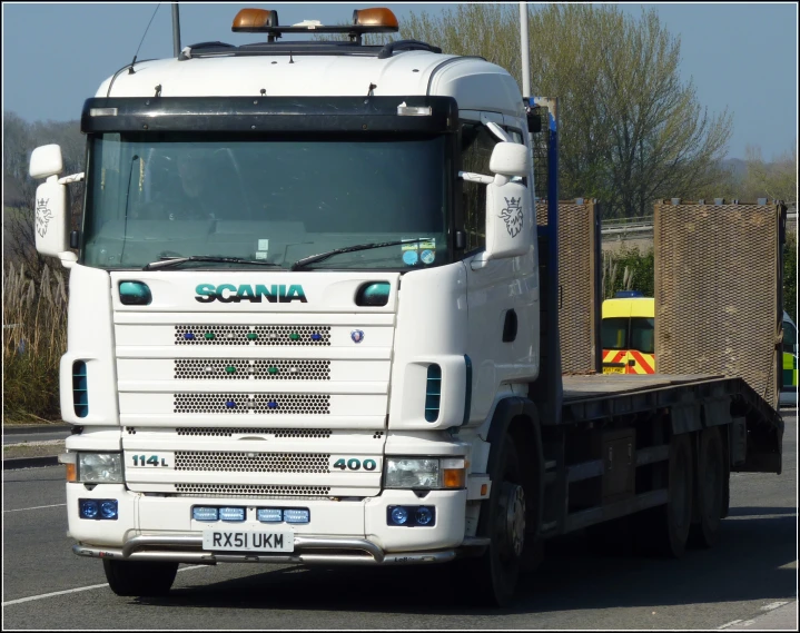 a white truck on the side of a road