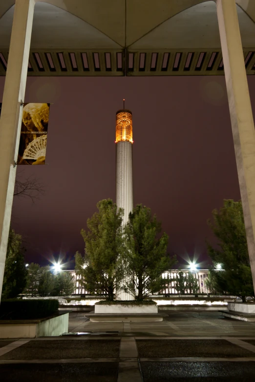 a clock tower is illuminated at night and it's on display