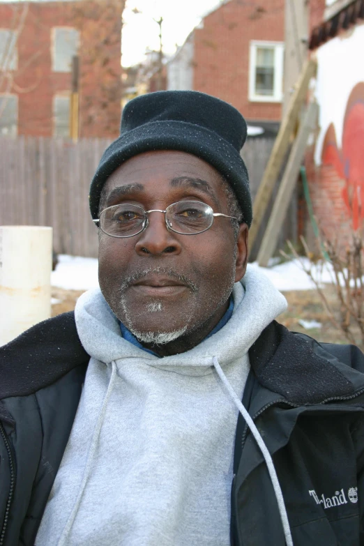 a man is looking into the camera while wearing a hat