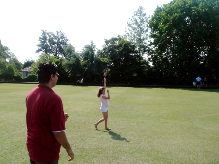 people playing a game with a frisbee in an open field
