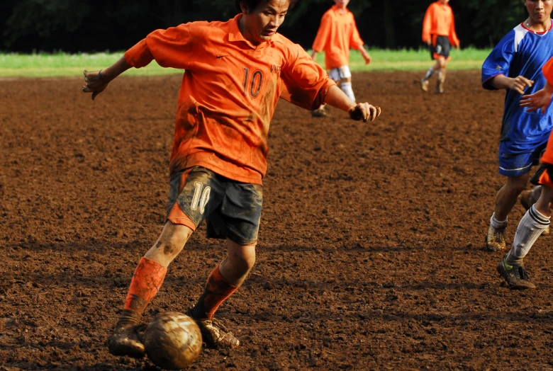 two soccer teams are chasing after the ball