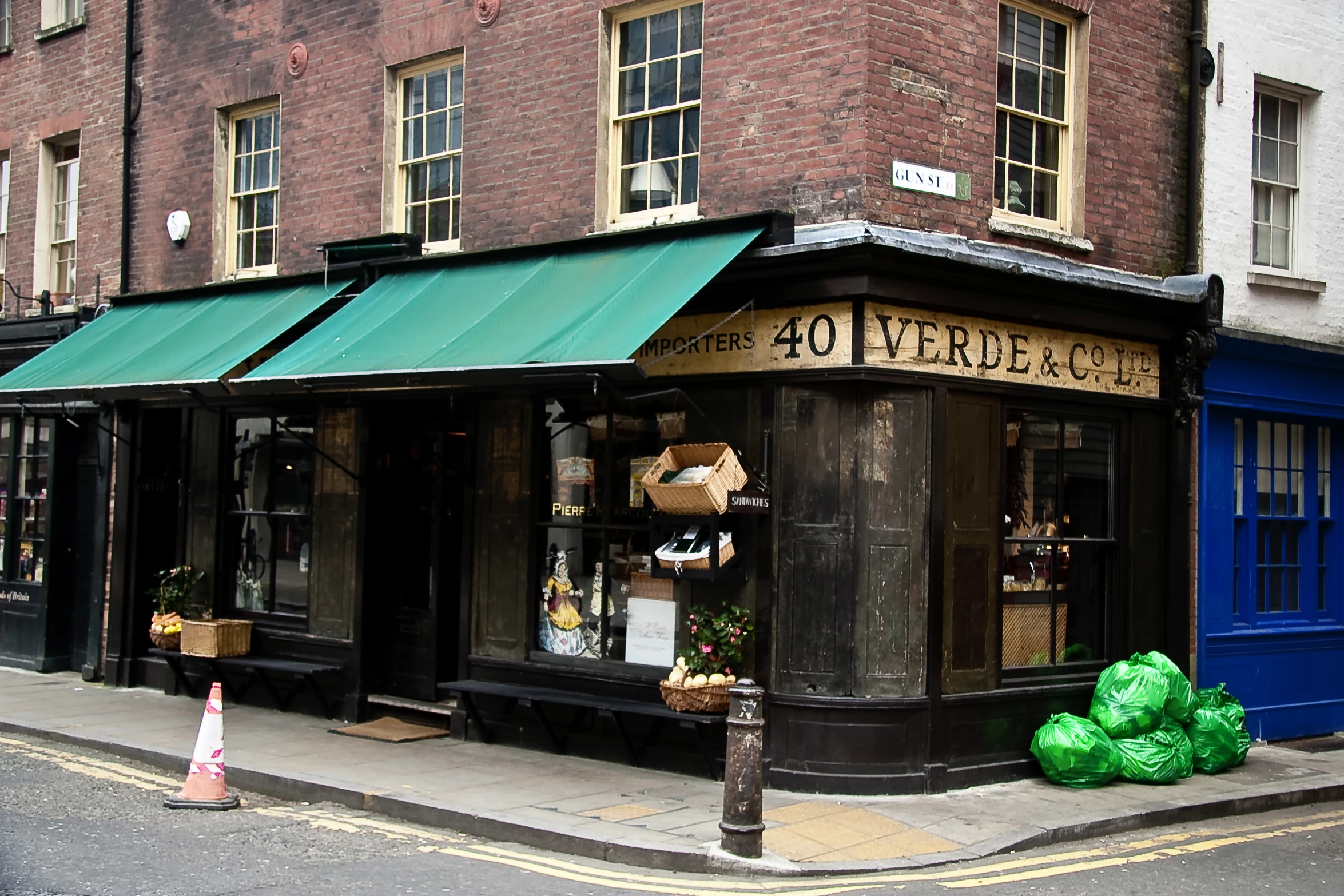 the store front is empty and some green bags outside