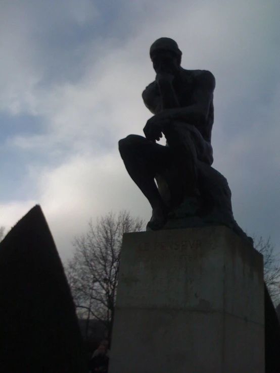 a sculpture is shown with trees in the background