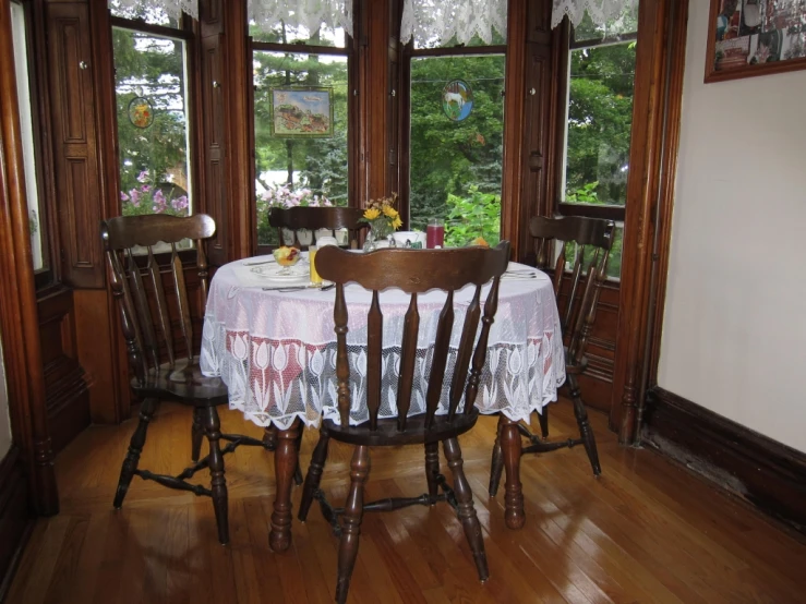 two tables and four chairs sitting in front of a window