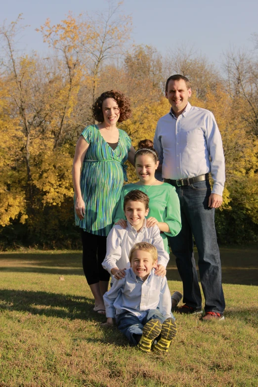 a family poses for a family po while dressed up and posing for the camera