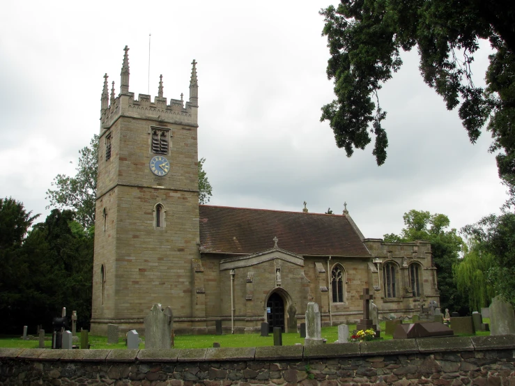 an old, rundown cemetery with a clock tower in the background