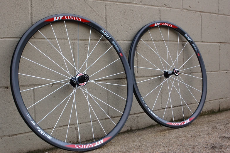 two black rims with red letters on a wall