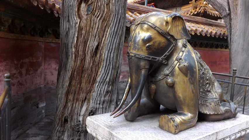 a statue sitting near a tree in an area