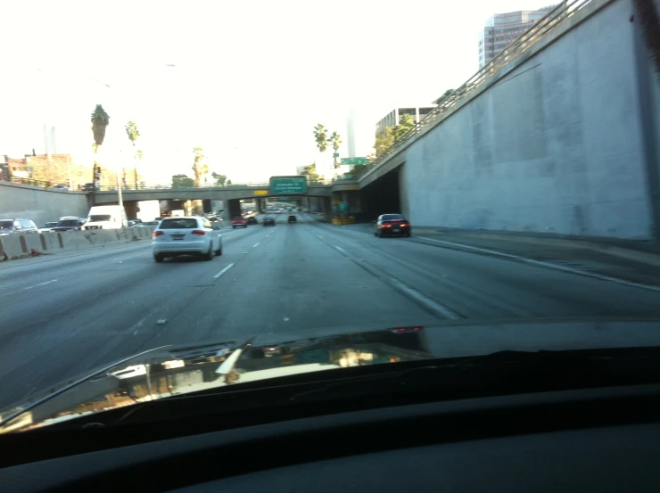 a car drives down the road, as cars wait to be on it