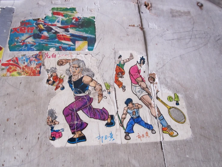 street art with various stickers on the sidewalk