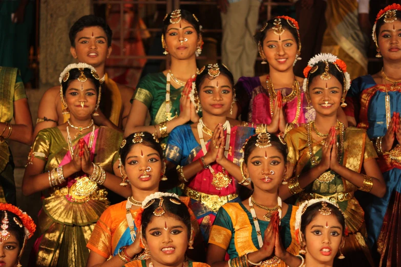 several beautiful indian women posing for a group picture