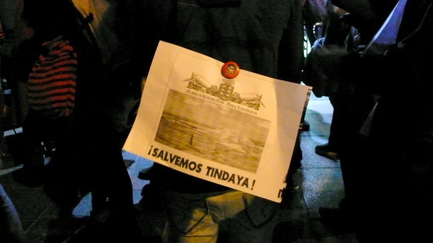 a man holds up a sign with the names of several important countries