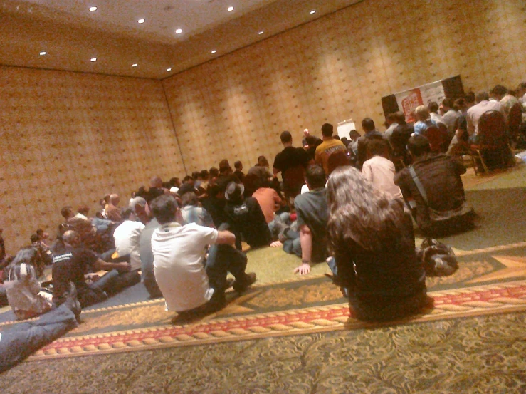 people sitting in an auditorium waiting to be awarded a lecture