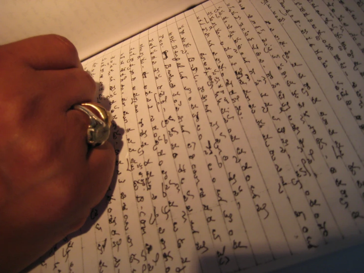 an open notebook with chinese characters and a ring