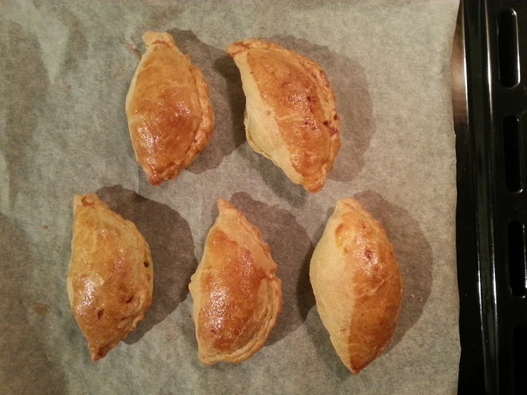 four puff pasties laying on a piece of paper