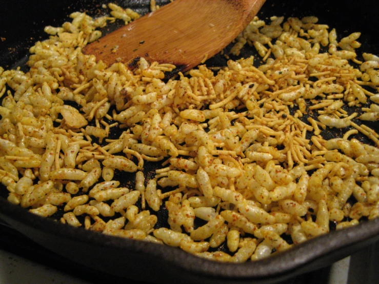 shrimp cooked in a set and served with a wooden spoon