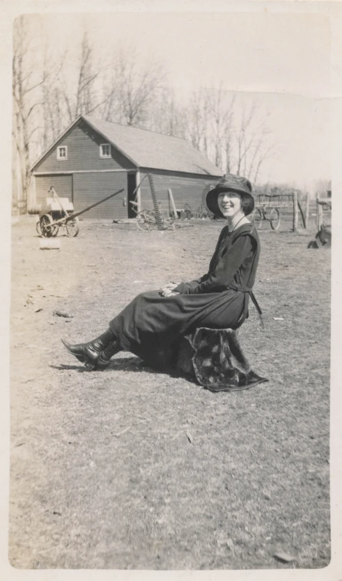 an old black and white po of a woman sitting outside