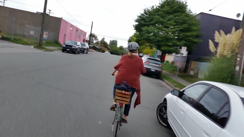 a person riding a bike down the middle of a street