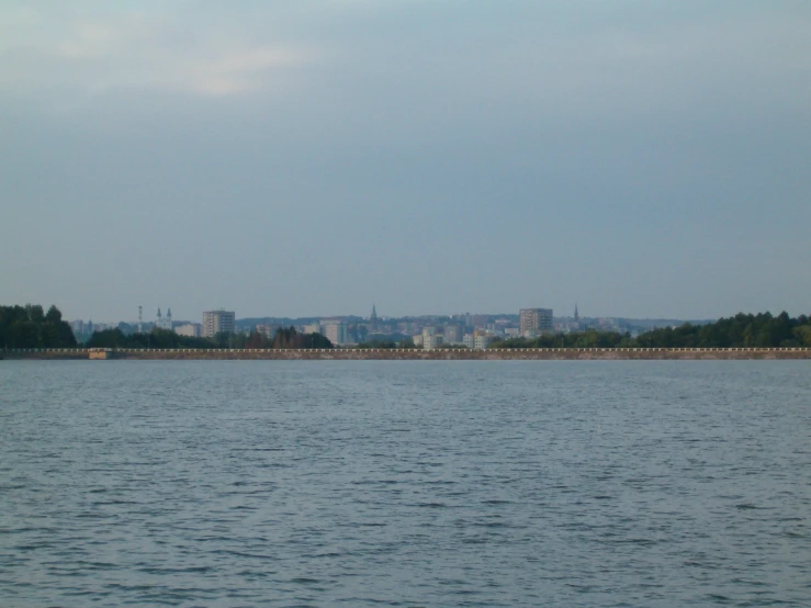 the water and some buildings on a shore line