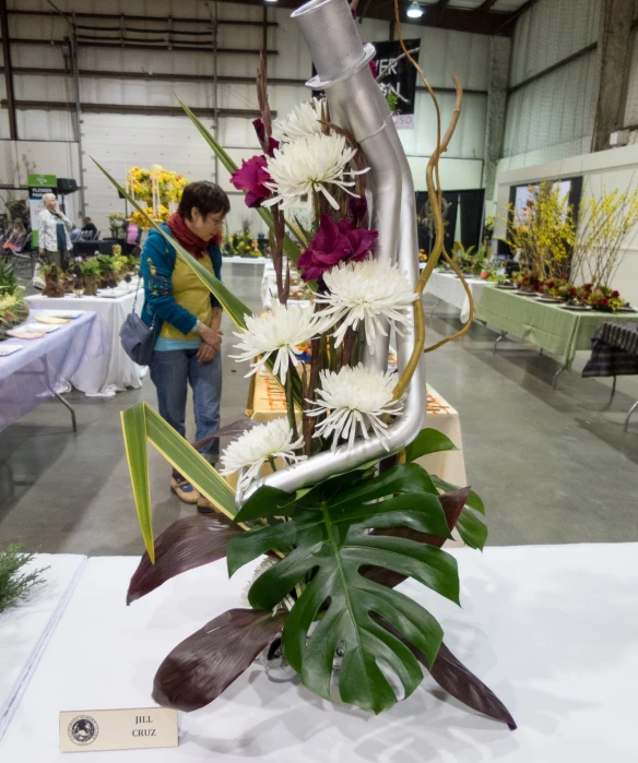 flowers are in the shape of a pipe and there are people standing around looking at them