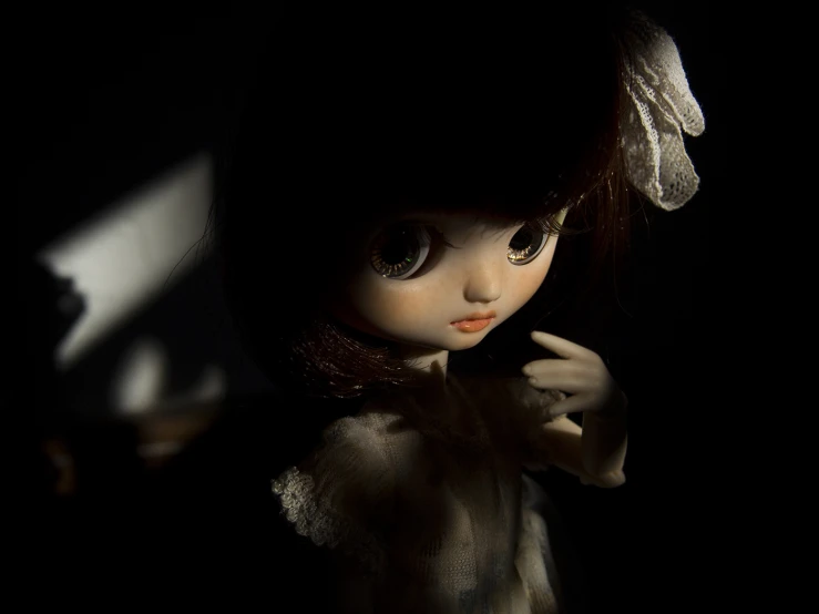 a close up view of a doll wearing a dress and a hat