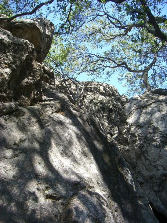 a person standing on top of a big rock formation