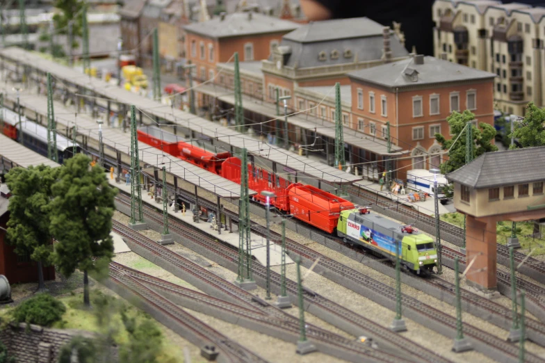 a toy train with many tracks that is connected to two buildings