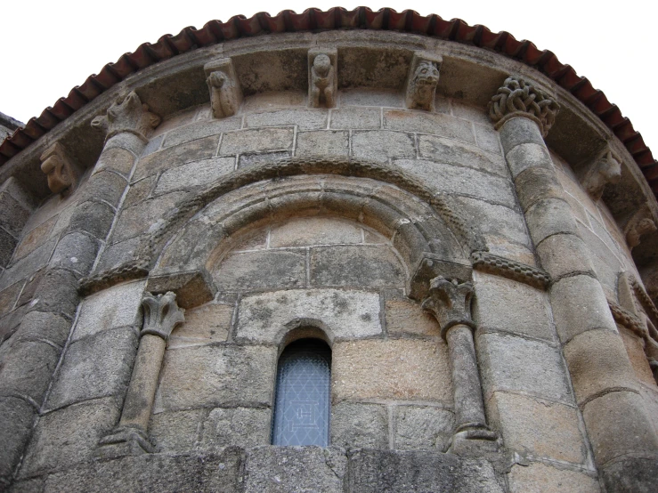 a window on a stone wall with arches