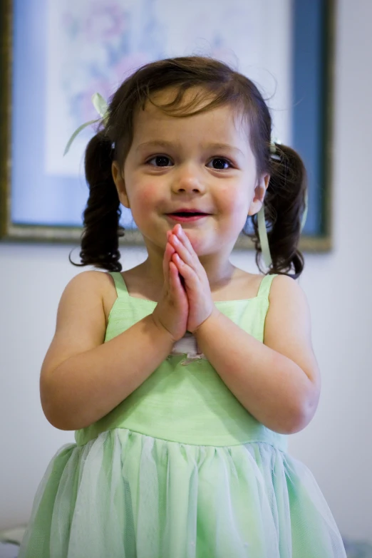 a  standing and clapping with her hands together