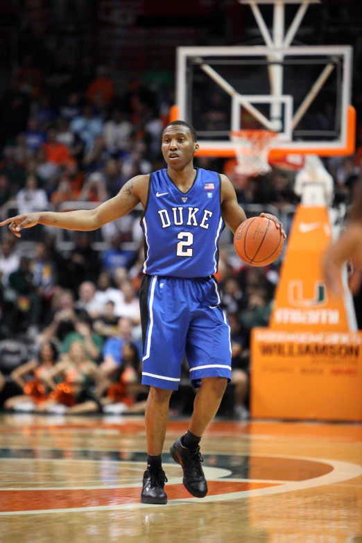 a basketball player dribbling the basketball as he is getting ready to make the play