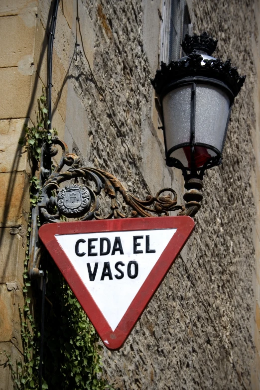 an old street sign attached to a brick wall