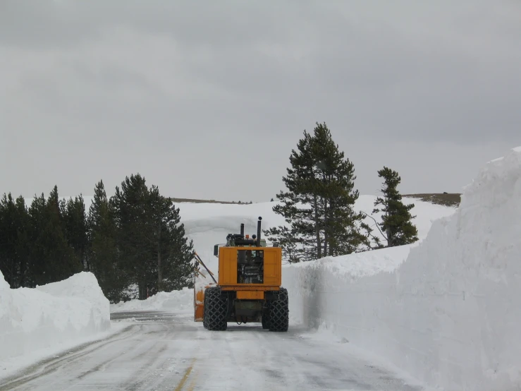 the snowplow has already cleared and is traveling on a path of snow