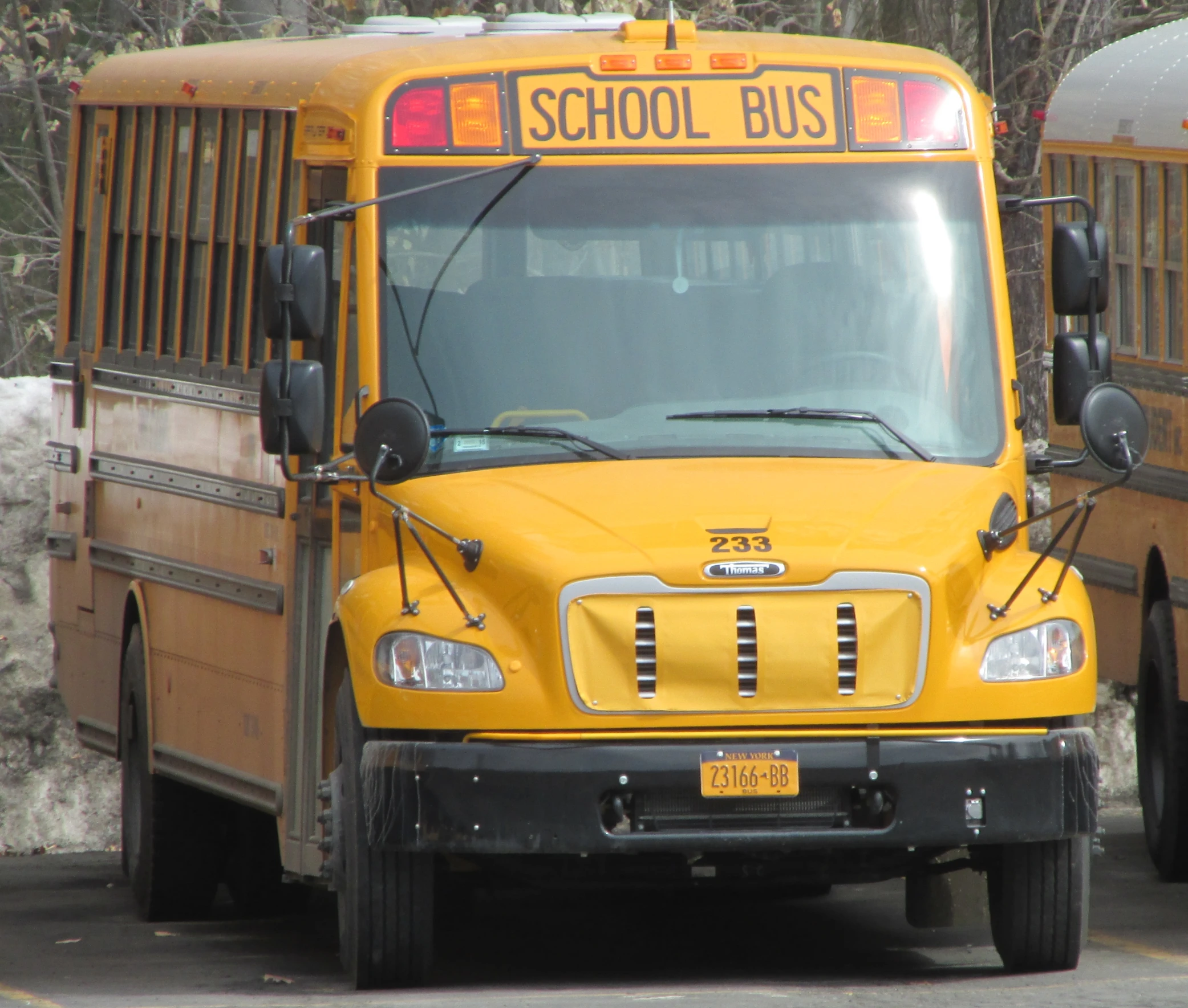 the front of a yellow school bus parked in a parking lot