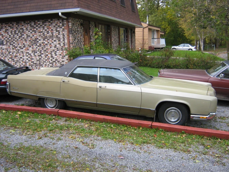 cars are parked in a driveway of a house