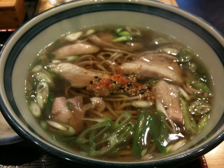 there is noodle, meat, and other vegetables inside the bowl