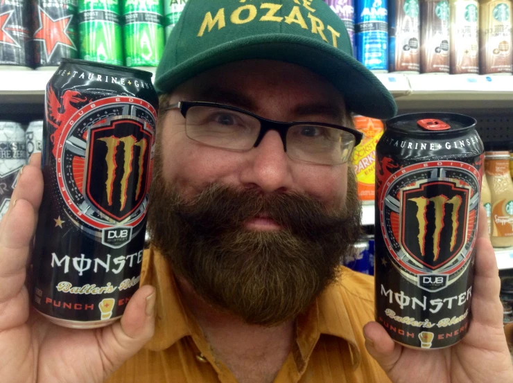 a man holding a can of monster energy drink