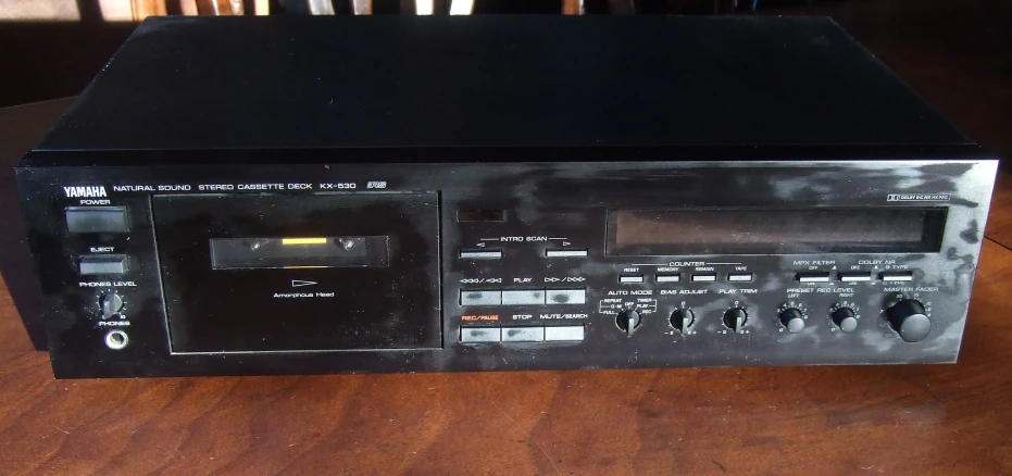 an old black radio on a wooden table