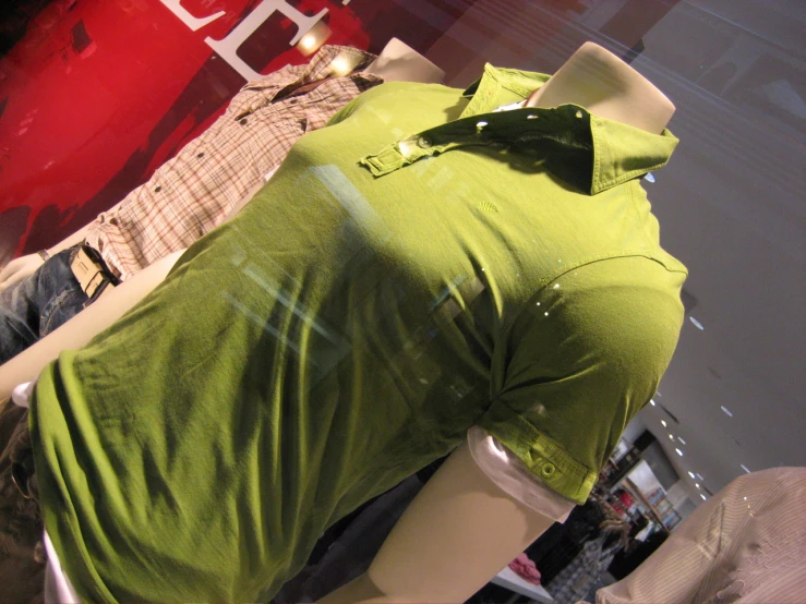 some men's shirts sitting on display in a store window