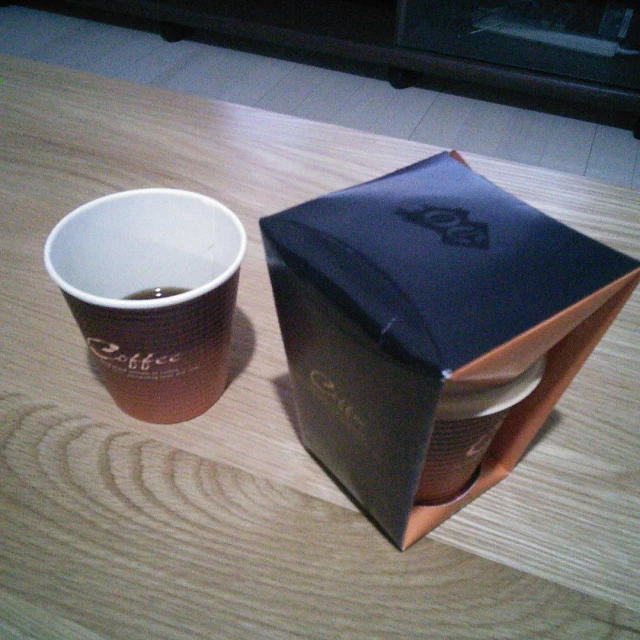 two cups that are next to some paper bags