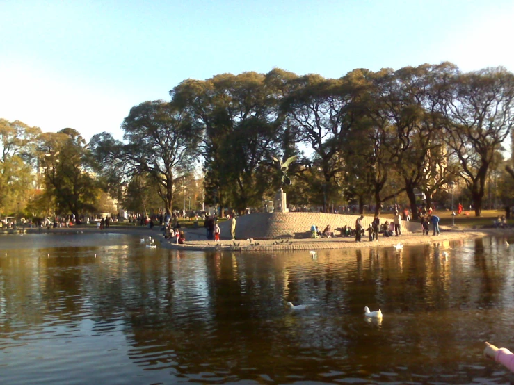 a lake filled with lots of water and birds flying above