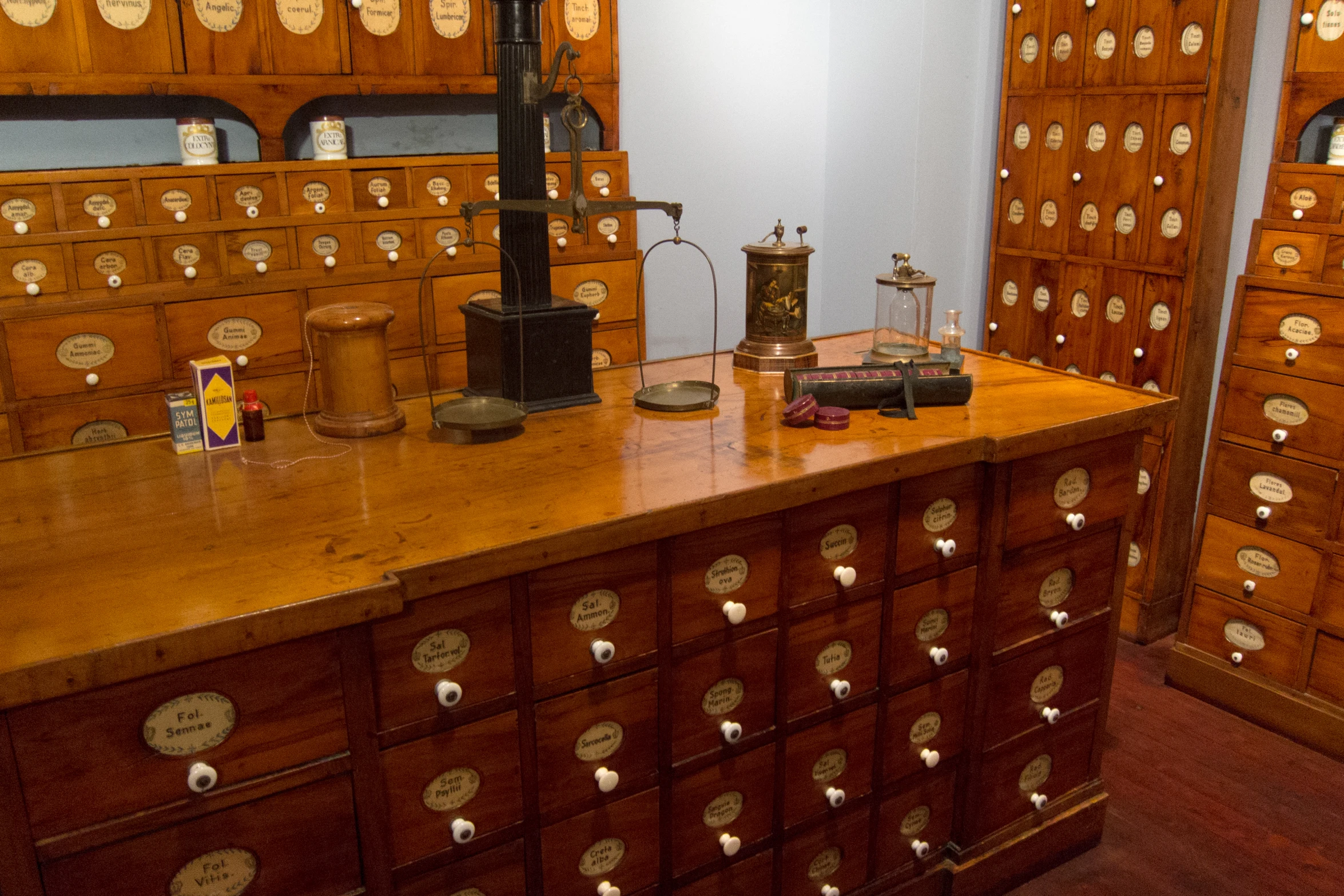 an old wooden desk has many wooden drawers