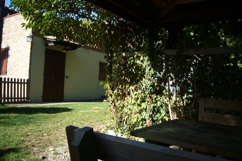 a small wooden table sitting on a green grass covered yard