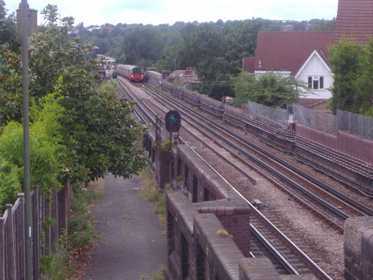 a train traveling past a group of houses